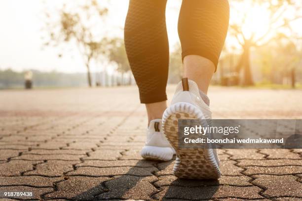 runner feet running on road closeup on shoe. - heel ストックフォトと画像