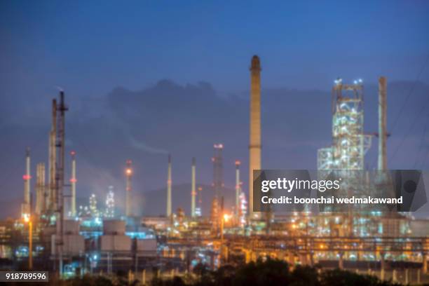 oil and gas refinery at twilight - petrochemical factory / focus blur - refine stock pictures, royalty-free photos & images