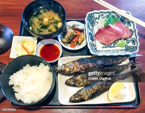 japanese style lunch meal, grilled sardines and yellowtail sashimi - amberjack fotografías e imágenes de stock