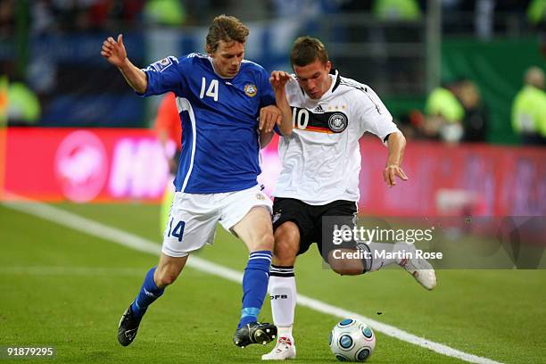 Lukas Podolski of Germany and Kasper Haemaelaeinen of Finland battle for the ball during the FIFA 2010 World Cup Group 4 Qualifier match between...