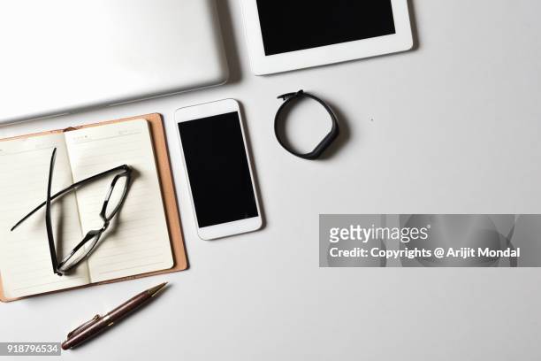 fitness tracker on office desk with laptop, tablet and smartphone top view white background copy space - aerial view desk stock pictures, royalty-free photos & images
