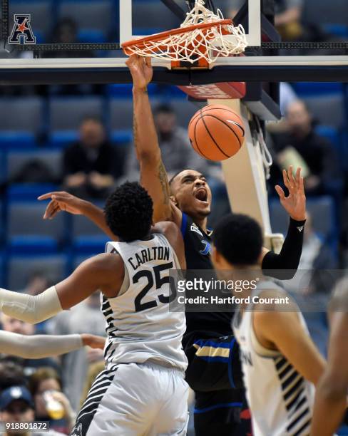 Tulsa's DaQuan Jeffries dunks in front of Connecticut's Josh Carlton at XL Center in Hartford, Conn., on Thursday, Feb. 15, 2018. Tulsa won, 73-71.