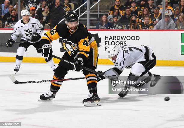 Zach Aston-Reese of the Pittsburgh Penguins takes a shot in front of Torrey Mitchell of the Los Angeles Kings at PPG Paints Arena on February 15,...