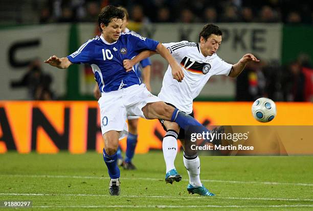 Mesut Oezil of Germany and Jari Litmanen of Finland battle for the ball during the FIFA 2010 World Cup Group 4 Qualifier match between Germany and...