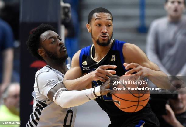 Connecticut's Antwoine Anderson pokes the ball away from Tulsa Golden Hurricane guard Corey Henderson Jr. At XL Center in Hartford, Conn., on...