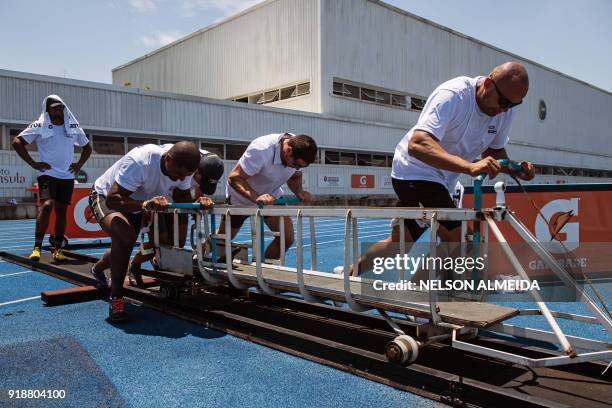 Picture taken on January 23, 2018 shows the Brazilian four-man bobsleigh team, piloted by Edson Bindilatti , pushing a training during a training...