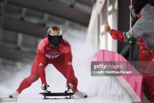 Sungbin Yun of Korea celebrates as he slides into the finish area to win the Men's Skeleton at Olympic Sliding Centre on February 16, 2018 in...