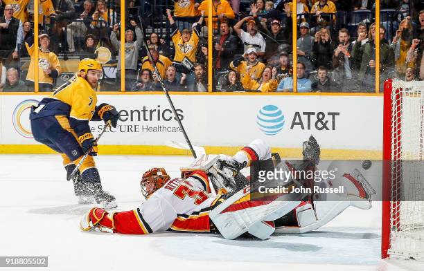 Yannick Weber of the Nashville Predators scores on a rebound against David Rittich of the Calgary Flames during an NHL game at Bridgestone Arena on...