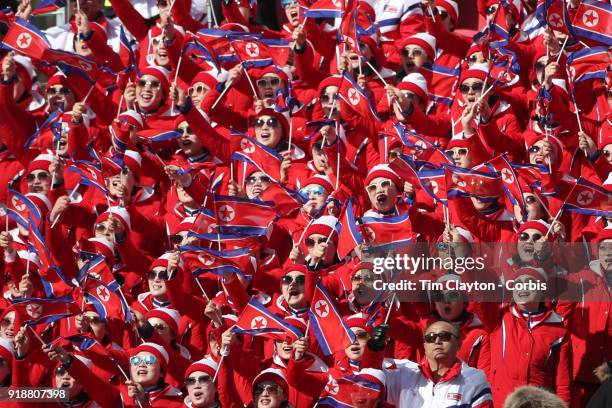 The North Korean choir cheer on Ryon-Hyang Kim from the Democratic People's Republic of Korea in action on the first run during the Alpine Skiing -...