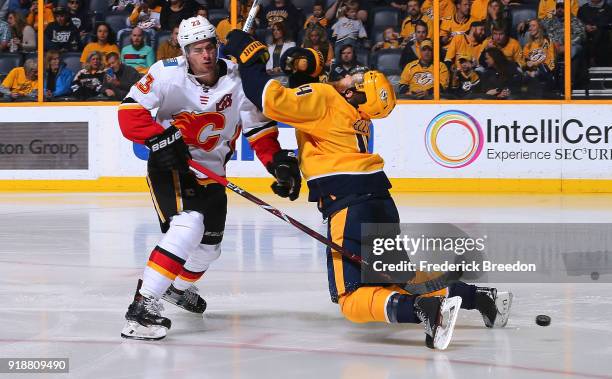 Ryan Ellis of the Nashville Predators draws a four minute penalty against Sean Monahan of the Calgary Flames during the second period at Bridgestone...