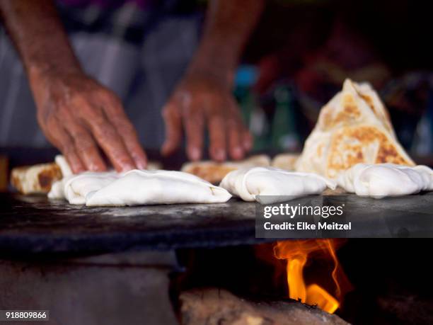 hands examining samosas cooking on hot plate - sri lankan culture stock pictures, royalty-free photos & images