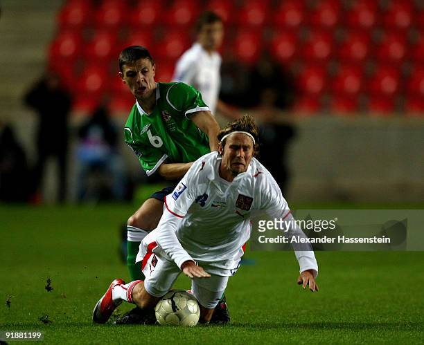 Jaroslav Plasil of Czech Republic is tackled by Christopher Baird of Northern Ireland during the FIFA 2010 World Cup Group 3 Qualifier match between...