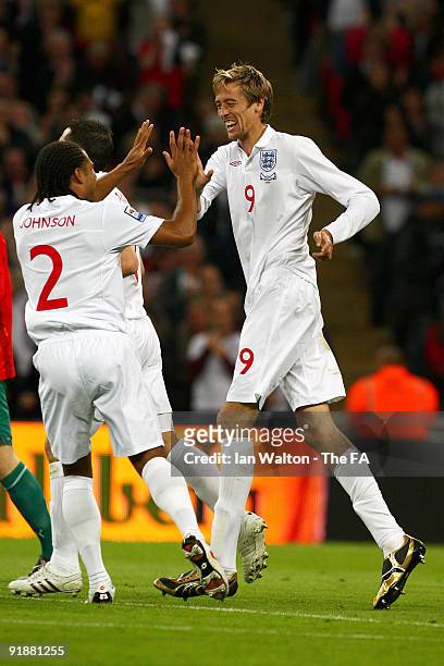 Peter Crouch of England celebrates after he scores during the first goal of the game during the FIFA 2010 World Cup Qualifying Group 6 match between...