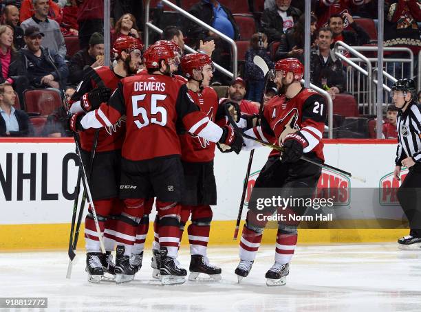 Derek Stepan of the Arizona Coyotes skates in to celebrate with teammates Brendan Perlini, Jason Demers and Clayton Keller after Perlini's second...