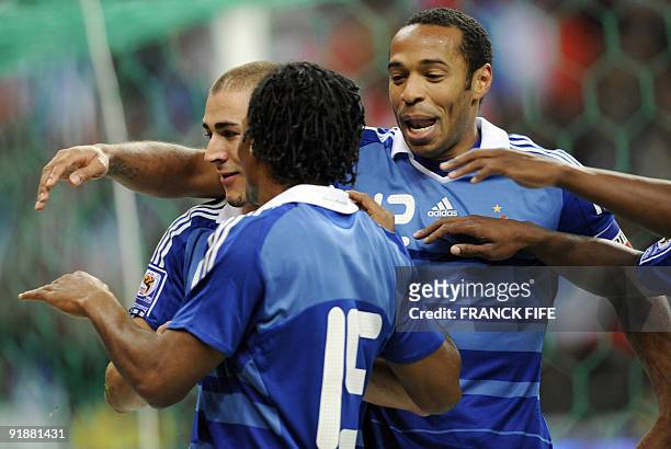 French forward Karim Benzema is congratulated by team mates Thierry Henry and Florent Malouda after scoring a goal during the World Cup 2010...