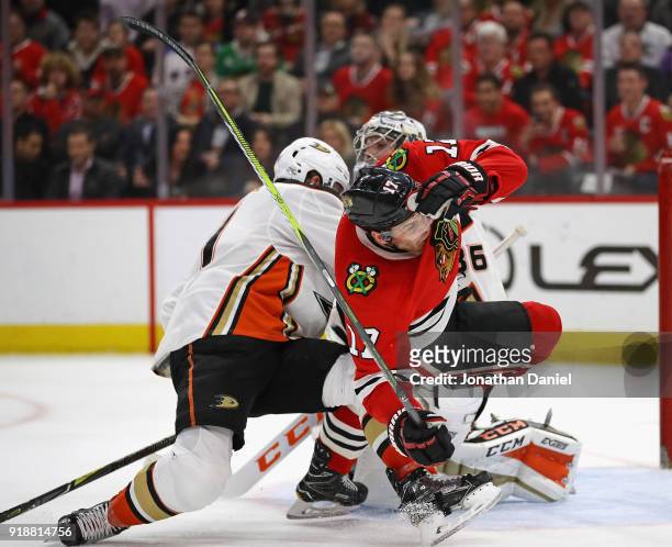 Lance Bouma of the Chicago Blackhawks hits the ice after colliding with Cam Fowler of the Anaheim Ducks in front of John Gibson at the United Center...