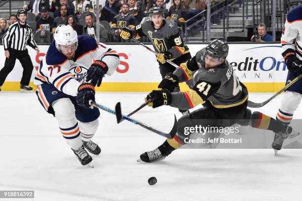 Oscar Klefbom of the Edmonton Oilers and Pierre-Edouard Bellemare of the Vegas Golden Knights battle for a loose puck during the game at T-Mobile...