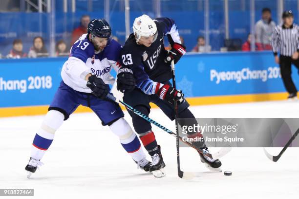 Troy Terry of the United States handles the puck against Tomas Starosta of Slovakia during the Men's Ice Hockey Preliminary Round Group B game at...