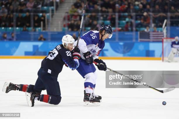 Michal Cajkovsky of Slovakia handles the puck against Troy Terry of the United States during the Men's Ice Hockey Preliminary Round Group B game at...