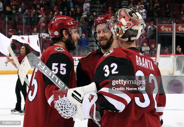 Jason Demers, Derek Stepan and goalie Antti Raanta of the Arizona Coyotes gather in celebration of a 5-2 victory against the Montreal Canadiens at...