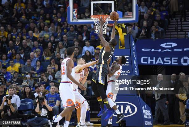 Kevin Durant of the Golden State Warriors goes up to shoot and score over Alex Len and Troy Daniels of the Phoenix Suns during an NBA basketball game...
