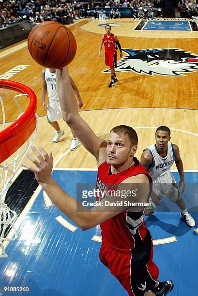 Rasho Nesterovic of the Toronto Raptors goes to the basket past Ramon Sessions of the Minnesota Timberwolves during the preseason game on October 9,...