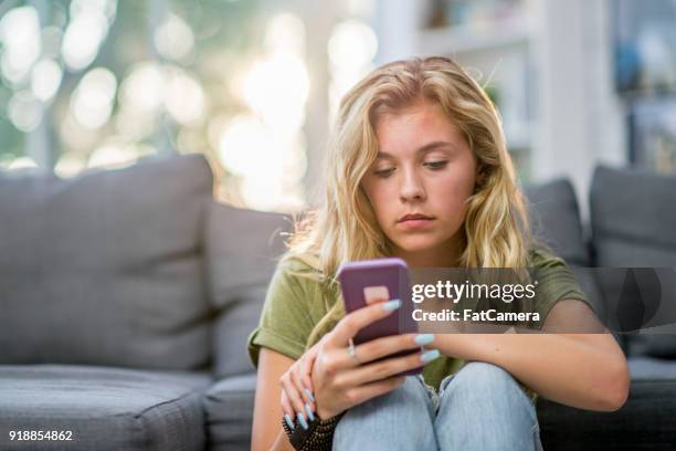 sad girl indoors - puberty girl stock pictures, royalty-free photos & images