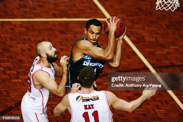 Mika Vukona of the Breakers grabs a rebound against Rhys Martin and Nick Kay of the Hawks during the round 19 NBL match between the New Zealand...