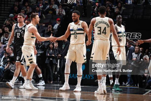 Giannis Antetokounmpo, Matthew Dellavedova, and Jabari Parker of the Milwaukee Bucks high five against the Brooklyn Nets on February 4, 2018 at...