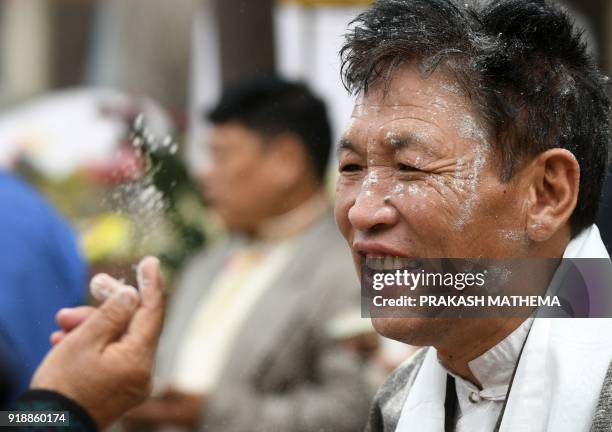 Tibetan in exiles throws flour to another during the celebrations marking the Lunar New Year or 'Lhosar' in Kathmandu on February 16, 2018. Lhosar is...