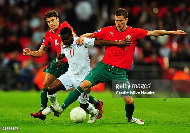 Shaun Wright-Phillips of England battles with Timofey Kalachev and Igor Shitov of Belarus during the FIFA 2010 World Cup Qualifying Group 6 match...