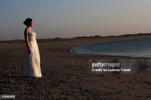 a bride on the beach - ludovic toinel stock pictures, royalty-free photos & images