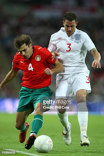 Wayne Bridge of England challenges Timofey Kalachev of Belarus during the FIFA 2010 World Cup Qualifying Group 6 match between England and Belarus at...