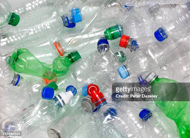 water bottles in recycling bin with recyclable caps - bottle photos et images de collection