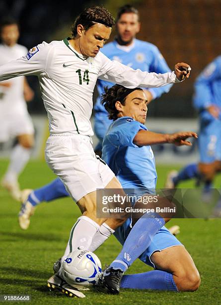 Zlatko Dedic of Sloveniaand Davide Simoncini of San Marino in action during the FIFA 2010 World Cup Group 3 Qualifying match between San Marino and...