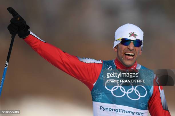 Morocco's Samir Azzimani crosses the finish line in men's 15km cross country freestyle at the Alpensia cross country ski centre during the...