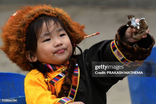 Young Exiled Tibetan looks on during celebrations marking the Lunar New Year or 'Lhosar' in Kathmandu on February 16, 2018. Lhosar is the New Year of...