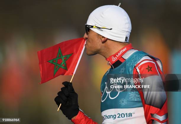Morocco's Samir Azzimani reacts as he crosses the finish line during the men's 15km cross country freestyle at the Alpensia cross country ski centre...