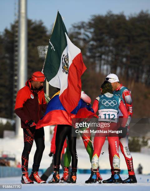 German Madrazo of Mexico holds the flag of Mexico as he celebrates with Sebastian Uprimny of Colombia, Samir Azzimani of Morocco, Pita Taufatofua of...