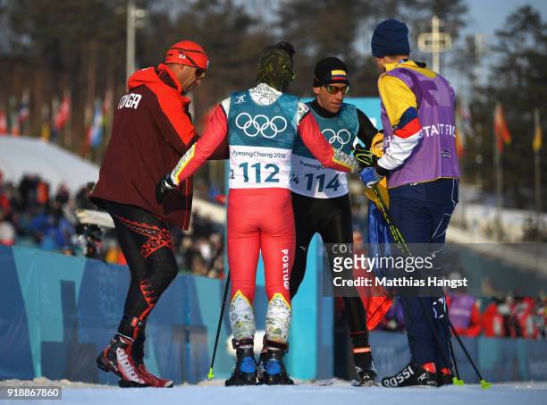 Sebastian Uprimny of Colombia reacts with Samir Azzimani of Morocco and Pita Taufatofua of Tonga after crossing the finish line during the...