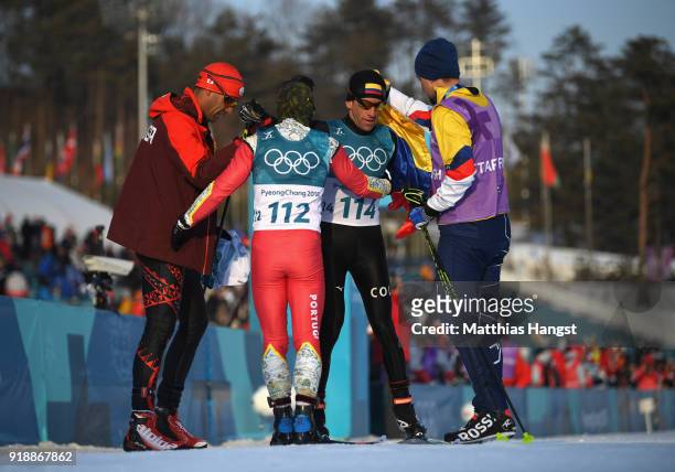Sebastian Uprimny of Colombia reacts with Samir Azzimani of Morocco and Pita Taufatofua of Tonga after crossing the finish line during the...