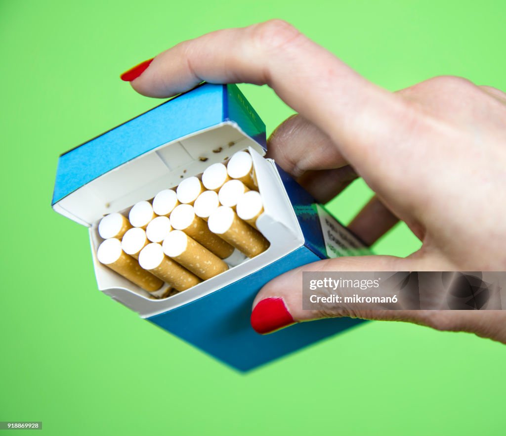 Woman's Hand taking cigarette from pack