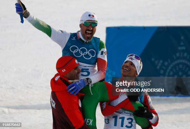 Tonga's Pita Taufatofua and Morocco's Samir Azzimani lift Mexico's German Madrazo onto their shoulders as they celebrate at the finish line in the...