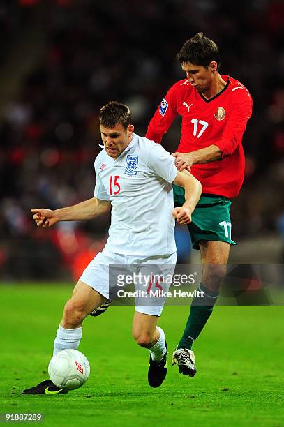 James Milner of England gets in front of Sergey Sosnovskiy of Belarus during the FIFA 2010 World Cup Qualifying Group 6 match between England and...