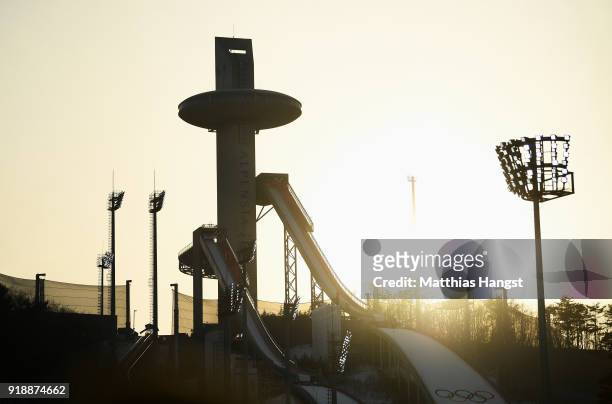 The sun sets behind the Alpensia Ski Jumping Centre during the Cross-Country Skiing Men's 15km Free at Alpensia Cross-Country Centre on February 16,...