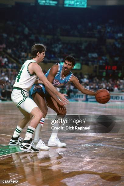 Reggie Theus of the Sacramento Kings looks to make a move against Danny Ainge of the Boston Celtics during a game played in 1987 at the Boston Garden...