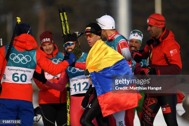 Sebastian Uprimny of Colombia celebrates with Simen Hegstad Krueger of Norway, Samir Azzimani of Morocco, Pita Taufatofua of Tonga and German Madrazo...