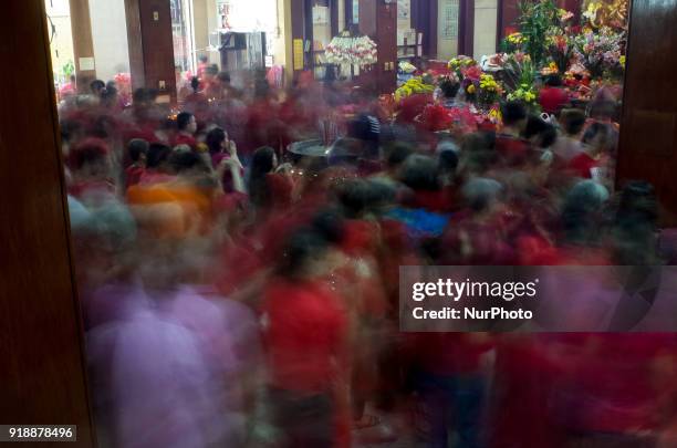 In this picture taken with a slow shutter speed, Chinese-Filipinos pray at the buddhist Seng Guan Temple in Manila, Philippines during Chinese New...