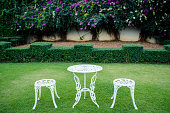 White vintage chairs in the garden ,selective focus