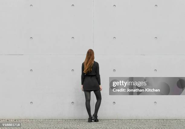 woman faces wall - indifference stock pictures, royalty-free photos & images